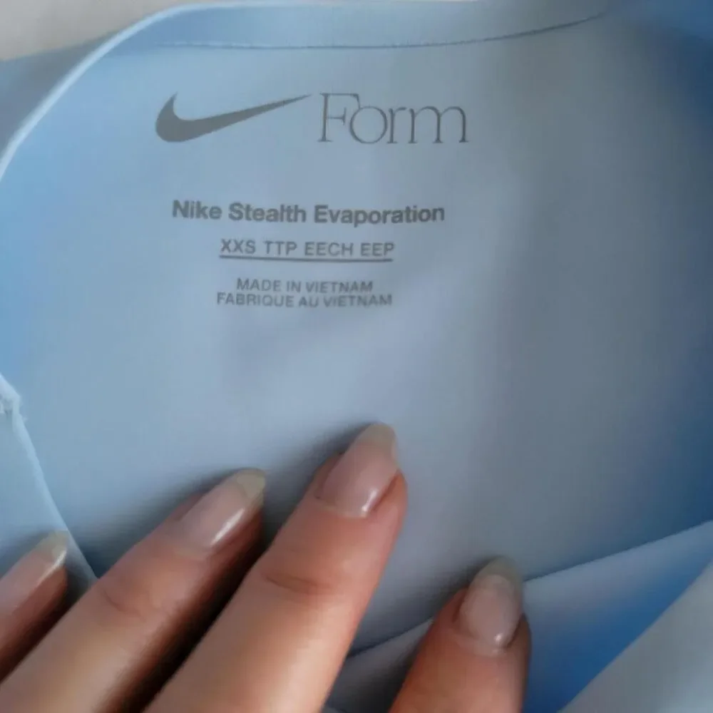 NWT NIKE FORM women's training top in baby blue, size xxs.